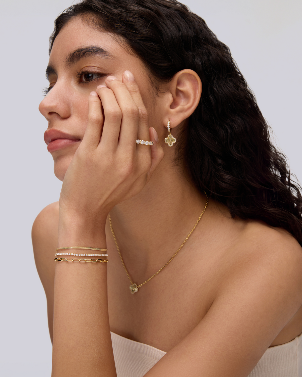 Woman wearing layered gold jewelry